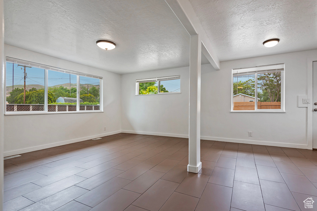 Interior space with a textured ceiling and a wealth of natural light