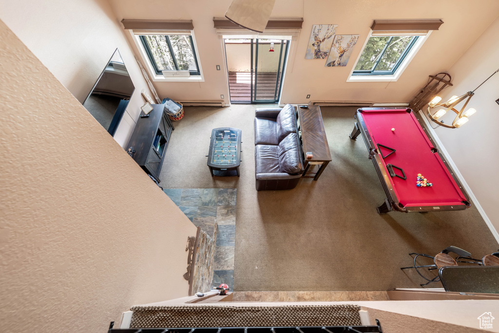 Living room featuring a towering ceiling, carpet flooring, a skylight, and pool table