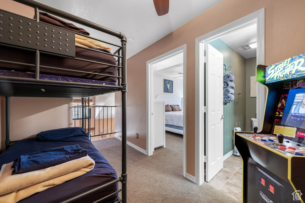 Carpeted bedroom with ceiling fan