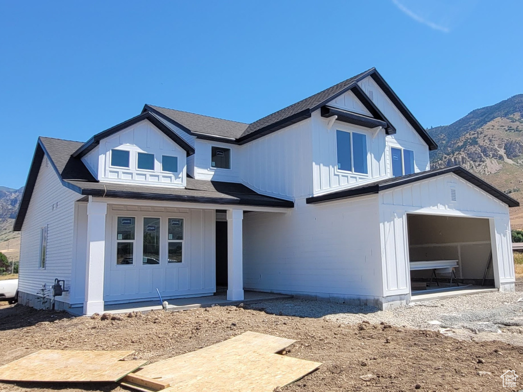 View of front of property featuring a garage and a mountain view