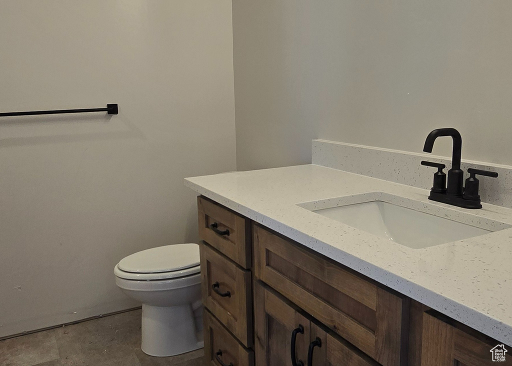 Bathroom featuring tile patterned floors, toilet, and vanity