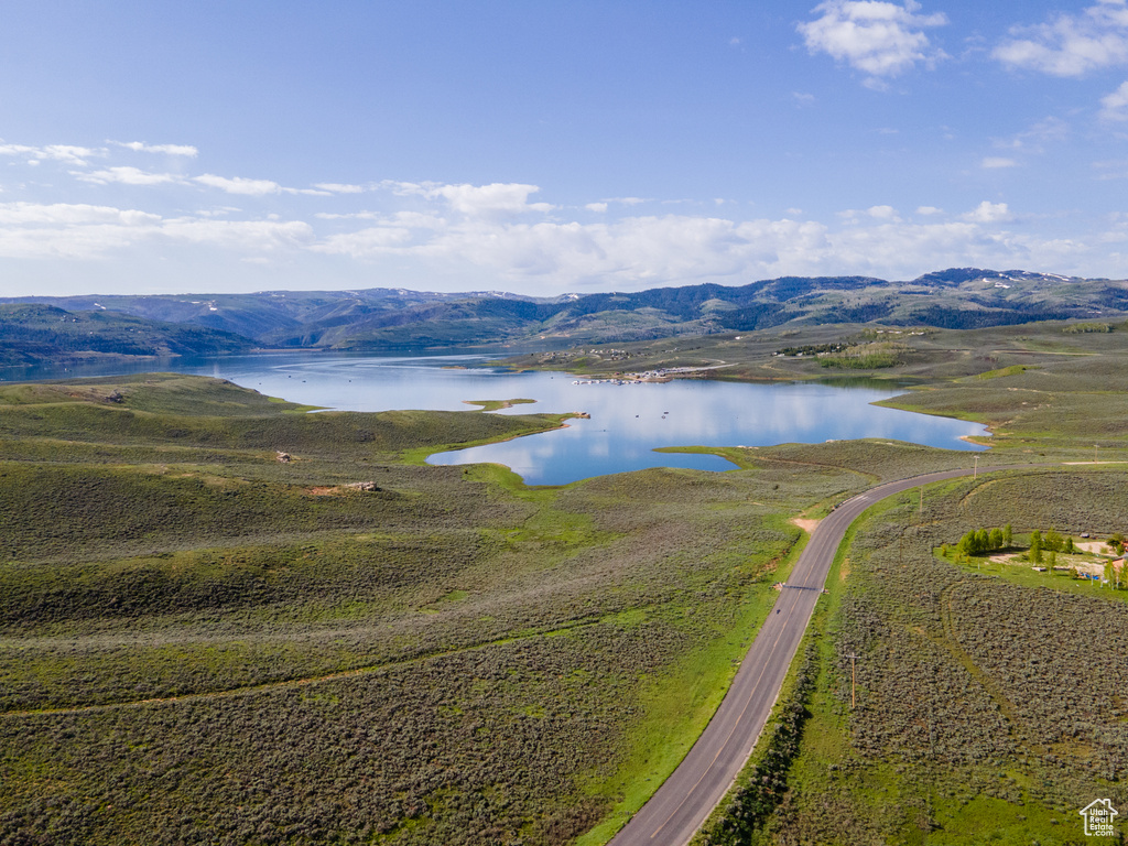 Birds eye view of property with a water and mountain view