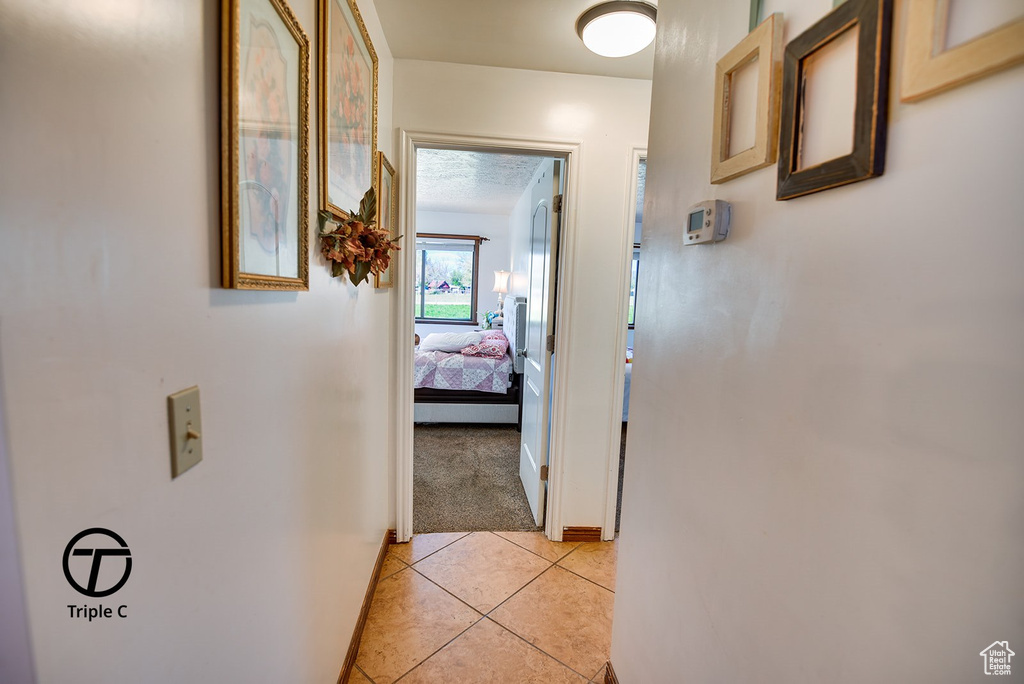 Corridor with light tile flooring