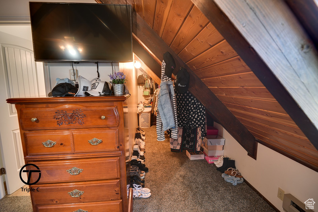 Interior space featuring wooden ceiling, carpet flooring, and vaulted ceiling