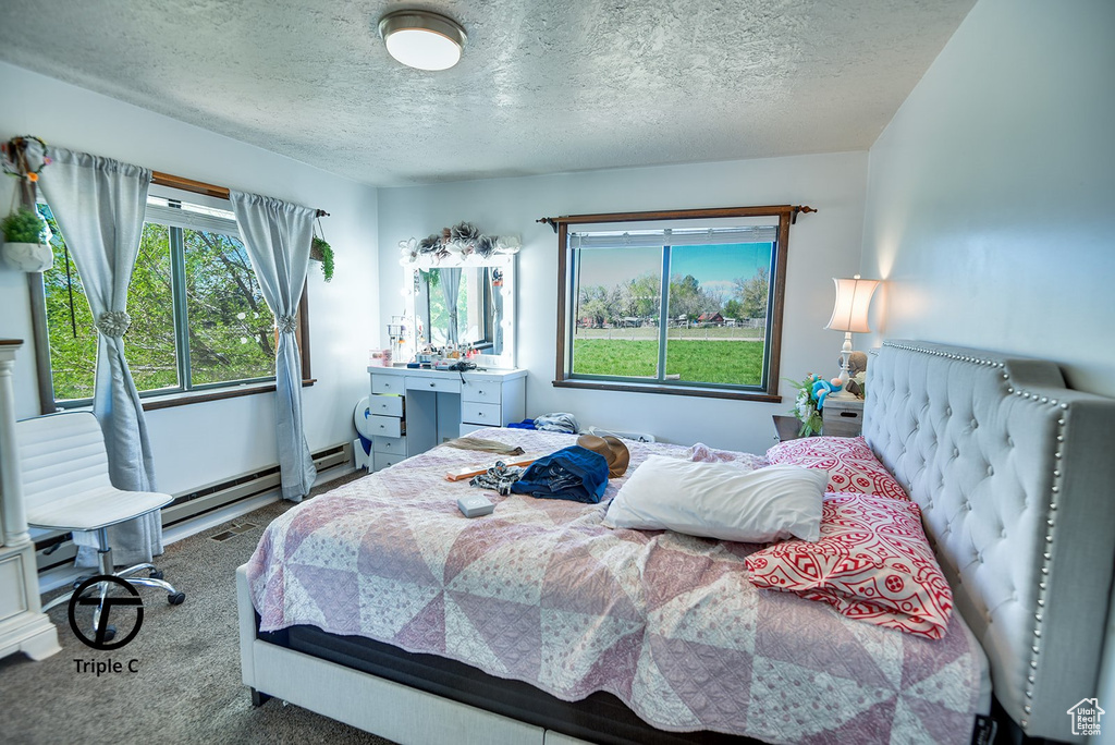 Bedroom featuring a textured ceiling and carpet
