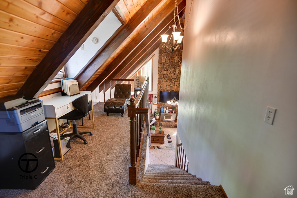 Interior space with carpet flooring, vaulted ceiling, a chandelier, and wooden ceiling