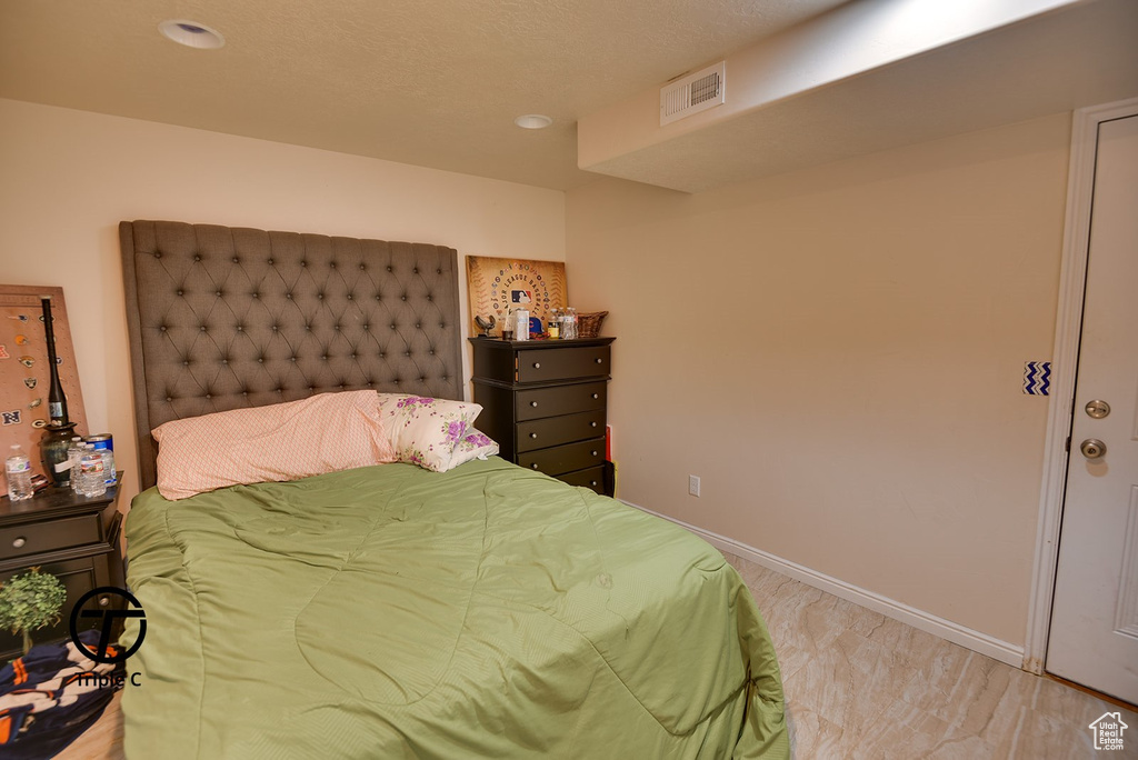 Bedroom with a textured ceiling