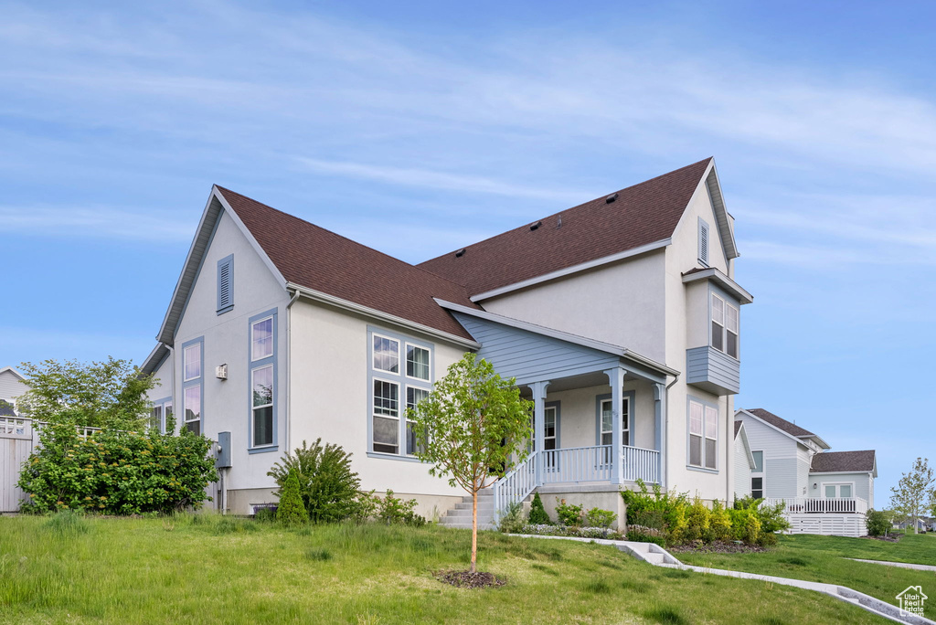 View of front of home with a front lawn and covered porch