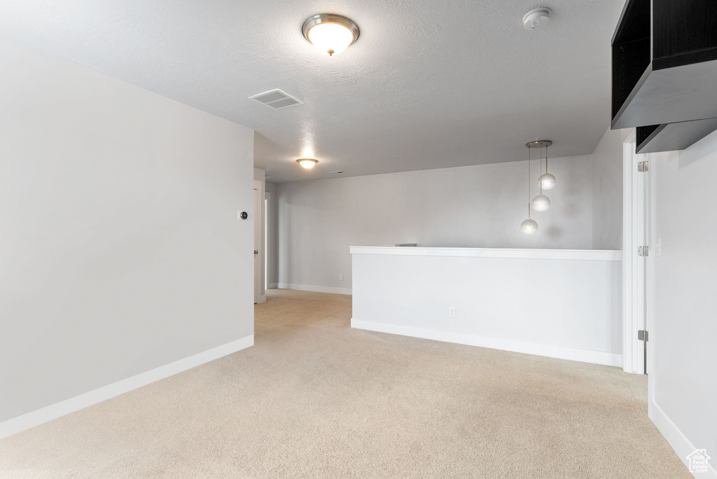 Spare room featuring light colored carpet