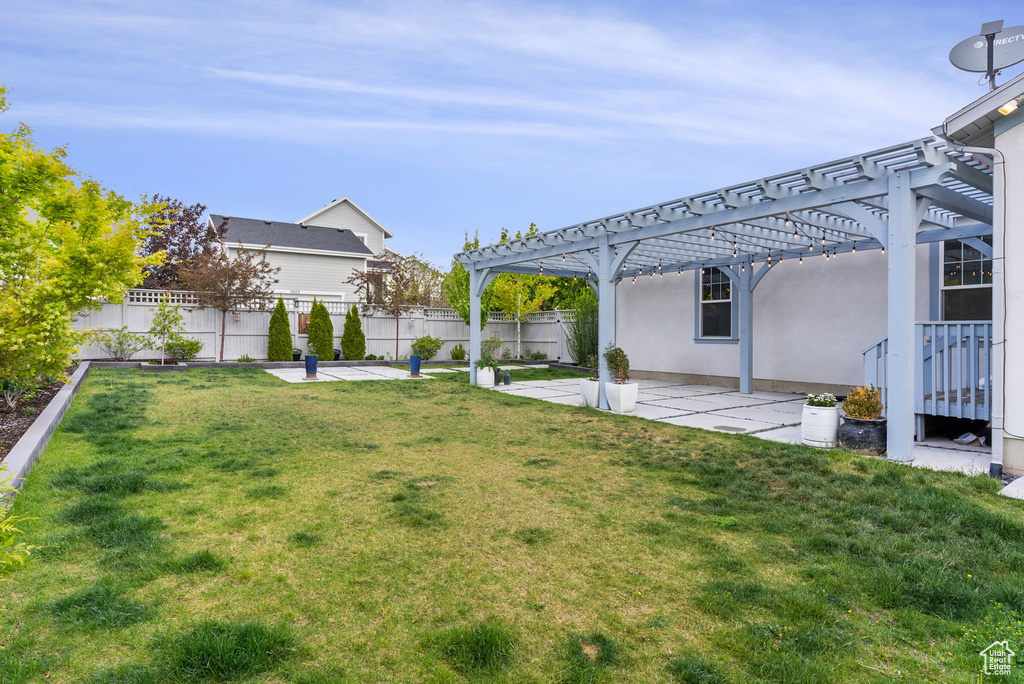 View of yard with a pergola and a patio