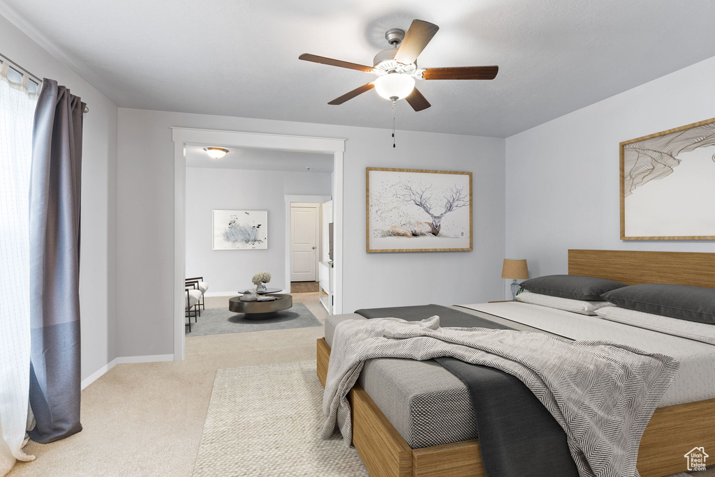 Carpeted bedroom with ceiling fan