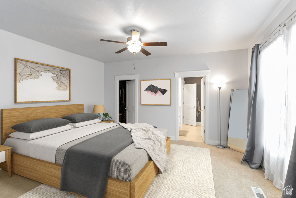 Carpeted bedroom with ceiling fan