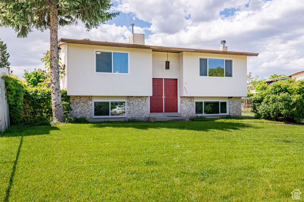 Back of house with a lawn