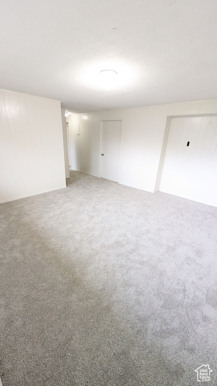 Carpeted empty room with a textured ceiling