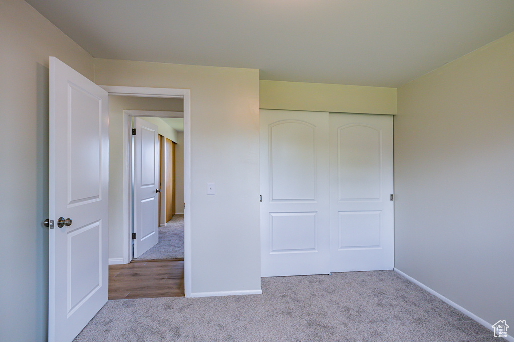 Unfurnished bedroom featuring hardwood / wood-style flooring and a closet