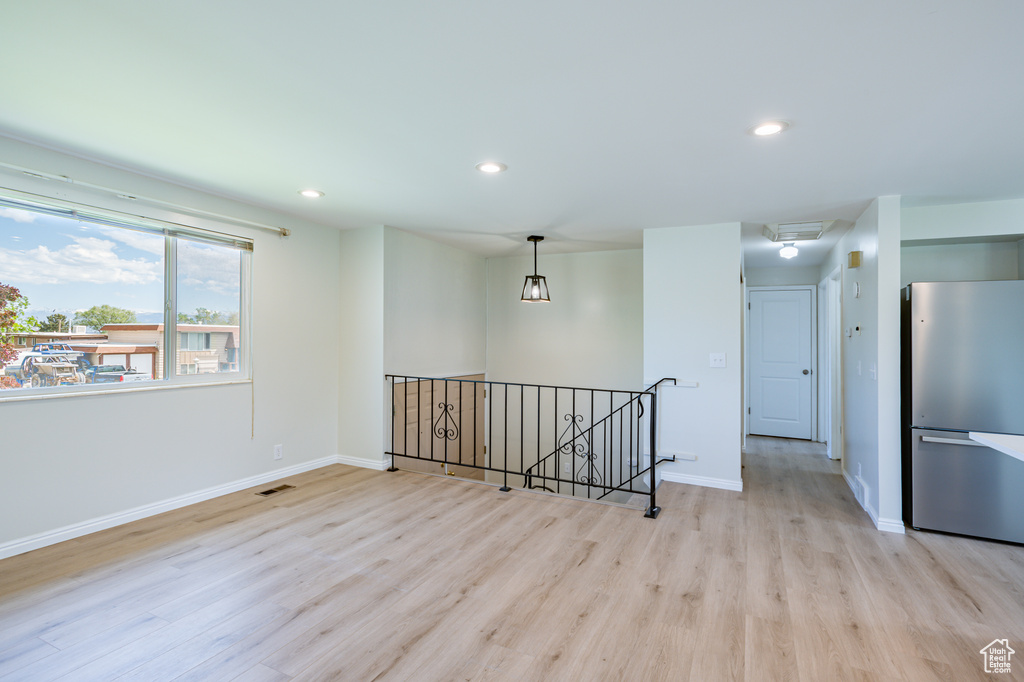 Unfurnished room featuring light wood-type flooring