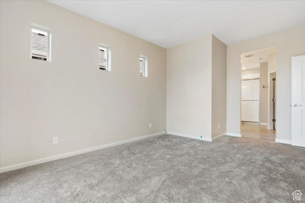 Spare room featuring light colored carpet