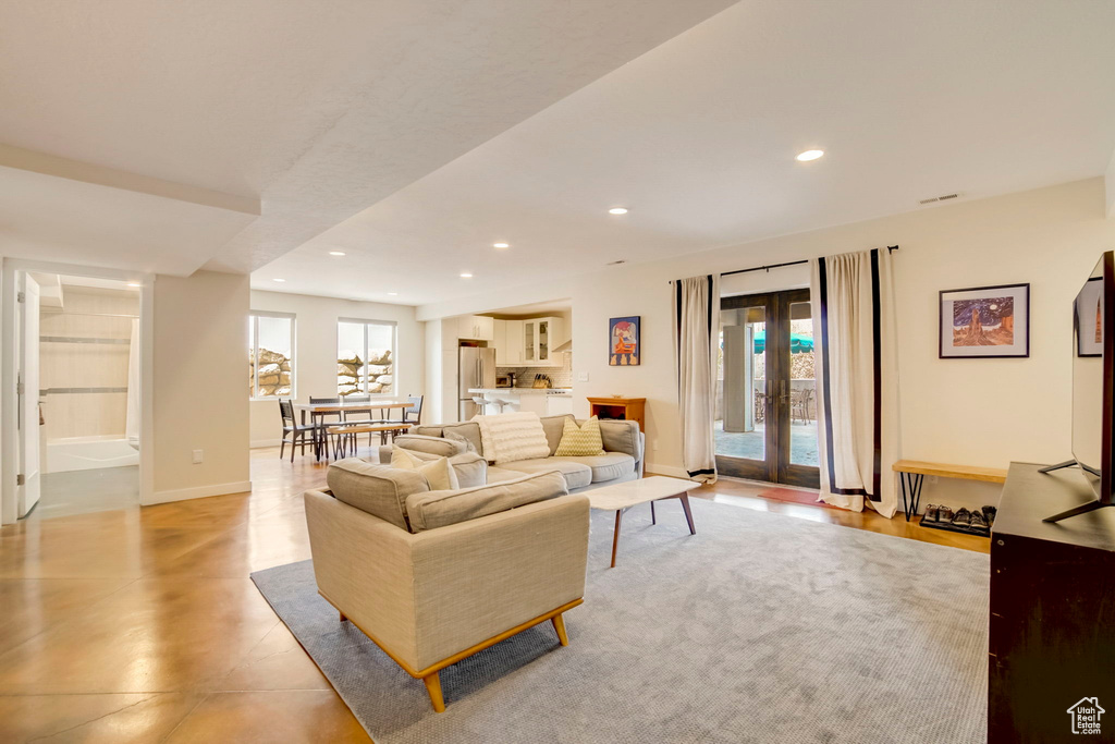 Living room with french doors, plenty of natural light, and light tile floors