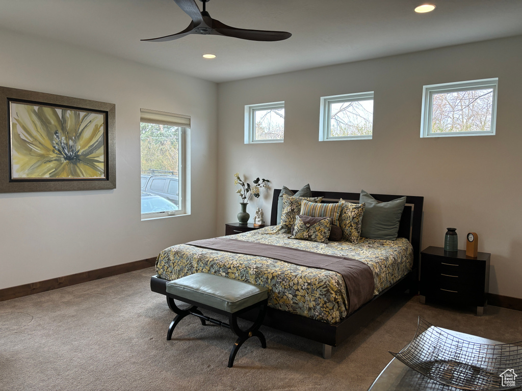 Bedroom featuring dark colored carpet and ceiling fan