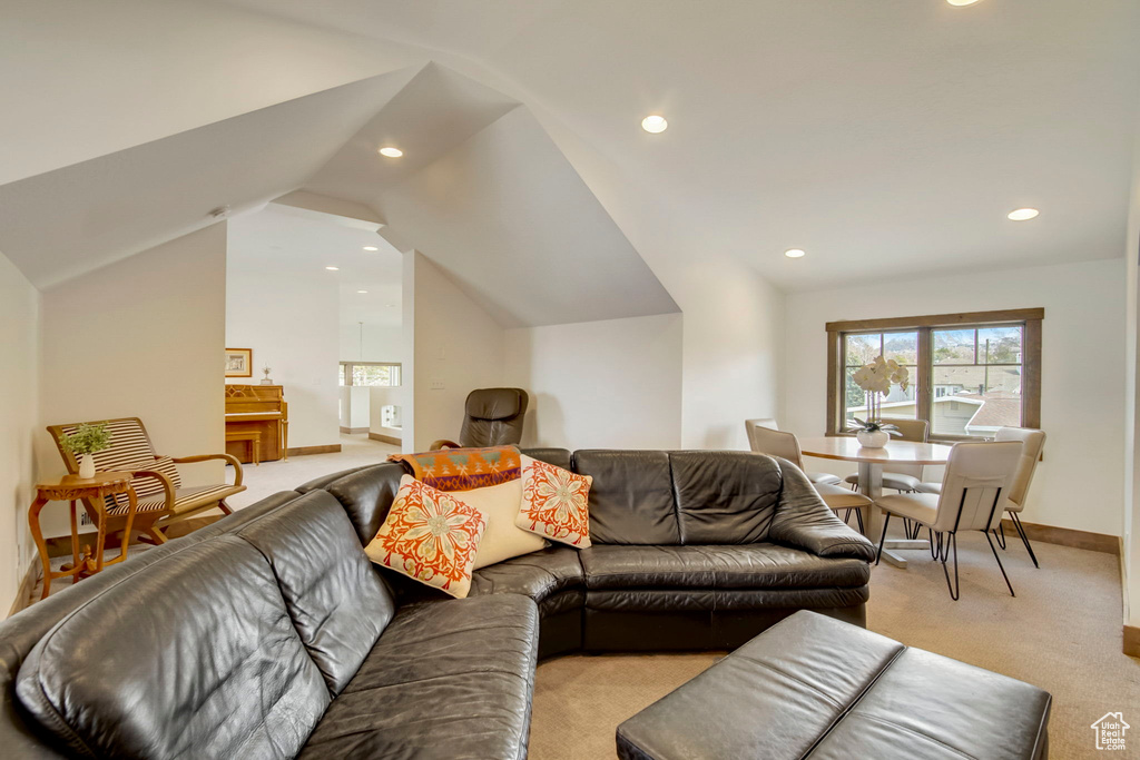 Living room with light carpet and lofted ceiling