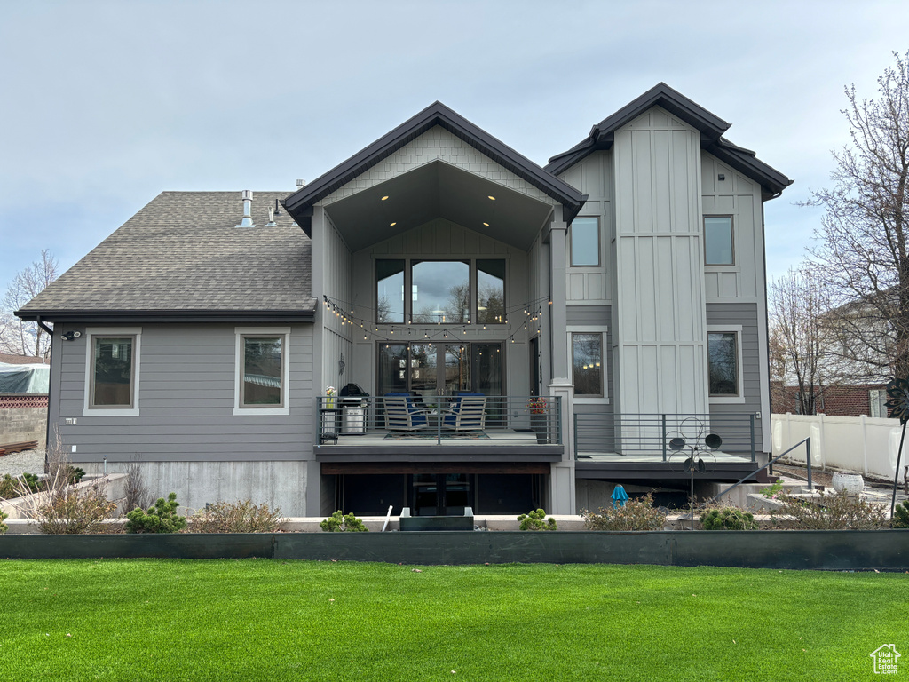 Back of house with a yard