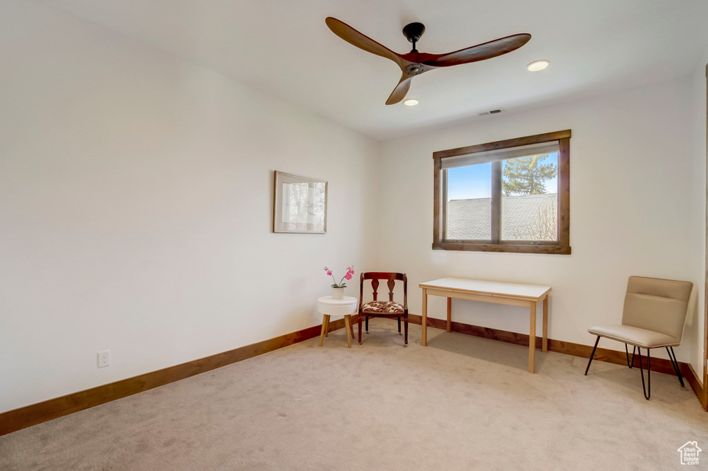 Living area with carpet flooring and ceiling fan