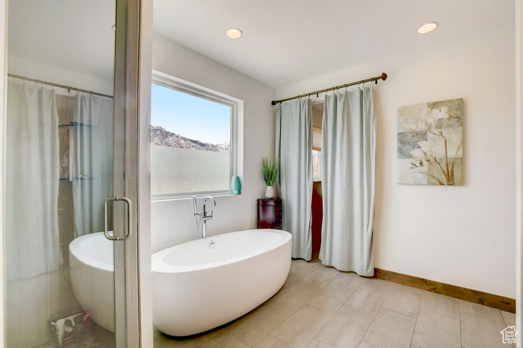 Bathroom featuring a bath to relax in and tile floors