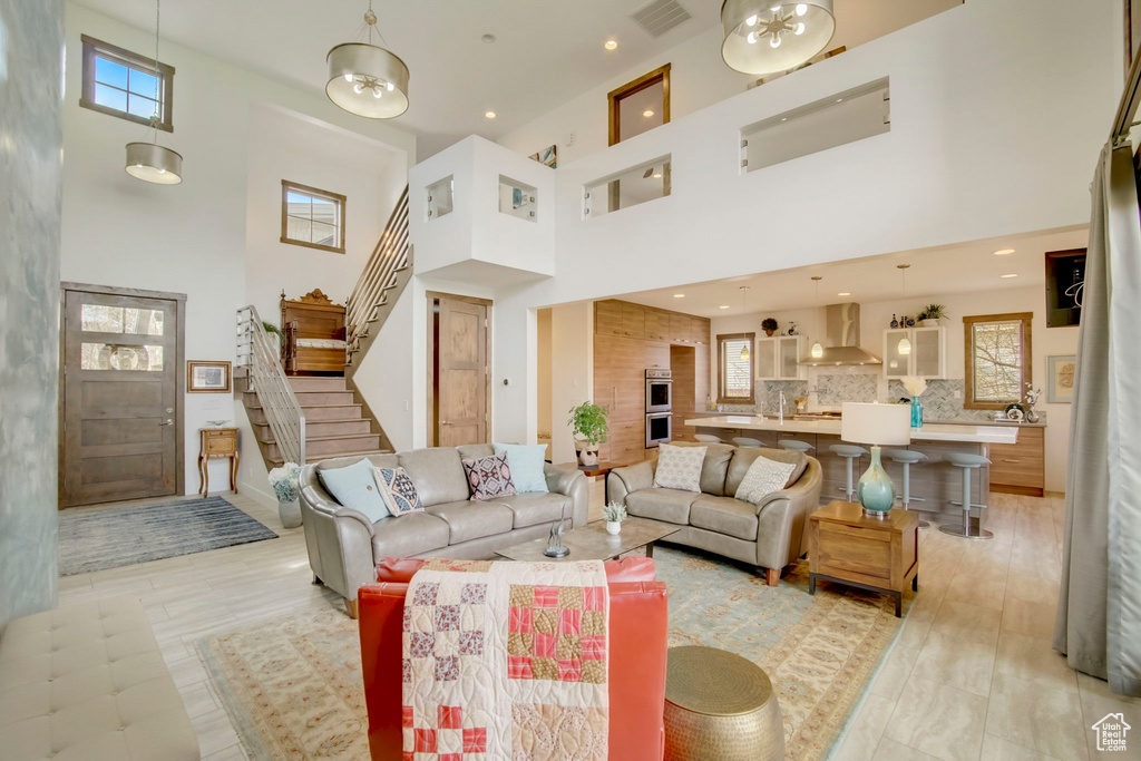 Tiled living room featuring a healthy amount of sunlight and a high ceiling