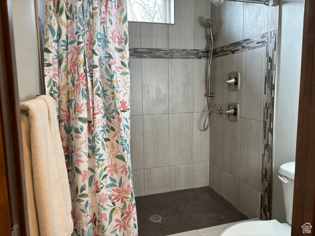 Bathroom featuring walk in shower and toilet