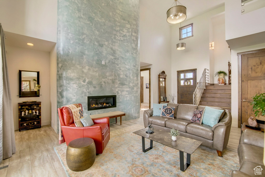 Living room featuring a high ceiling and hardwood / wood-style flooring