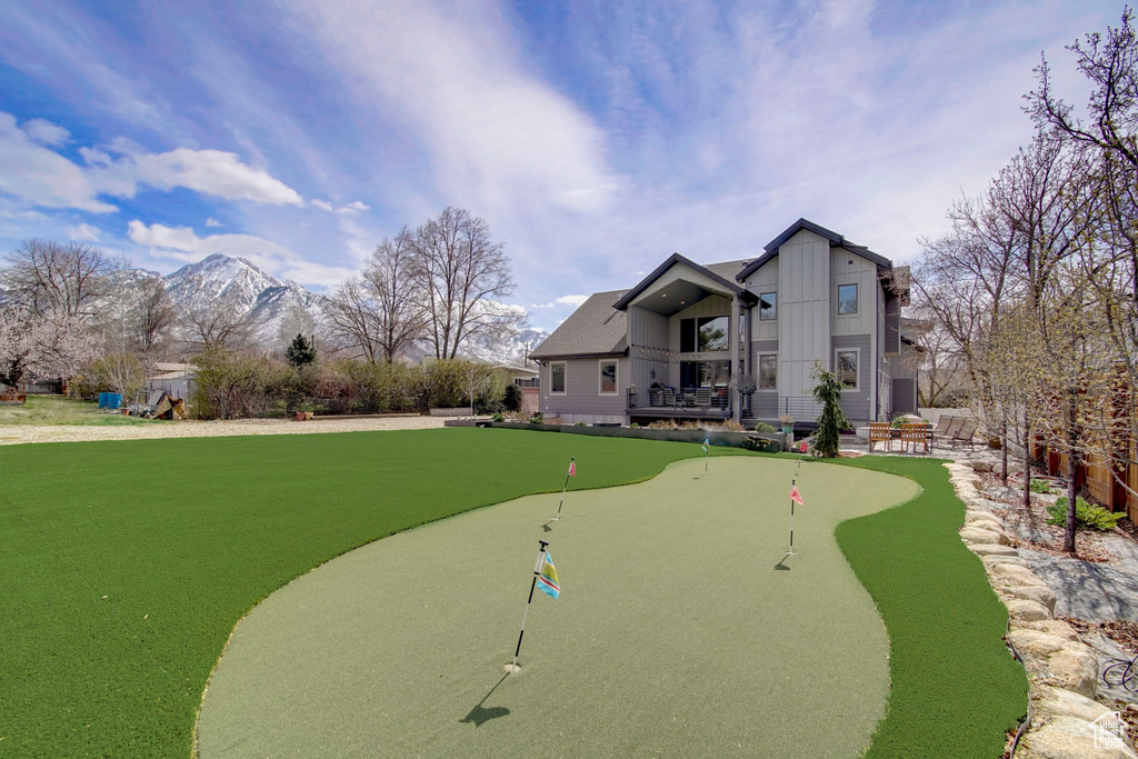 Surrounding community featuring a mountain view and a lawn