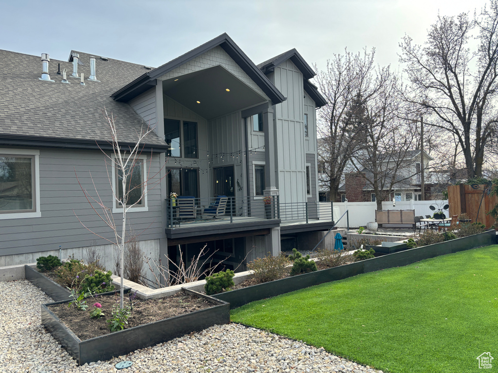 Rear view of house with a yard