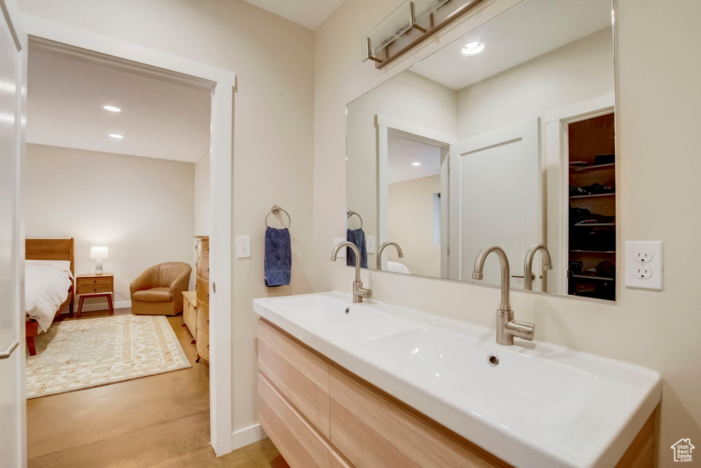 Bathroom with oversized vanity and wood-type flooring