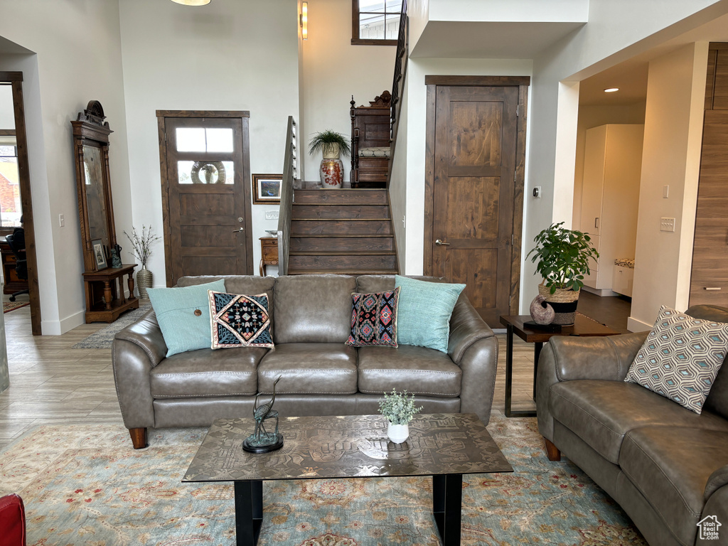 Living room featuring a high ceiling and hardwood / wood-style floors