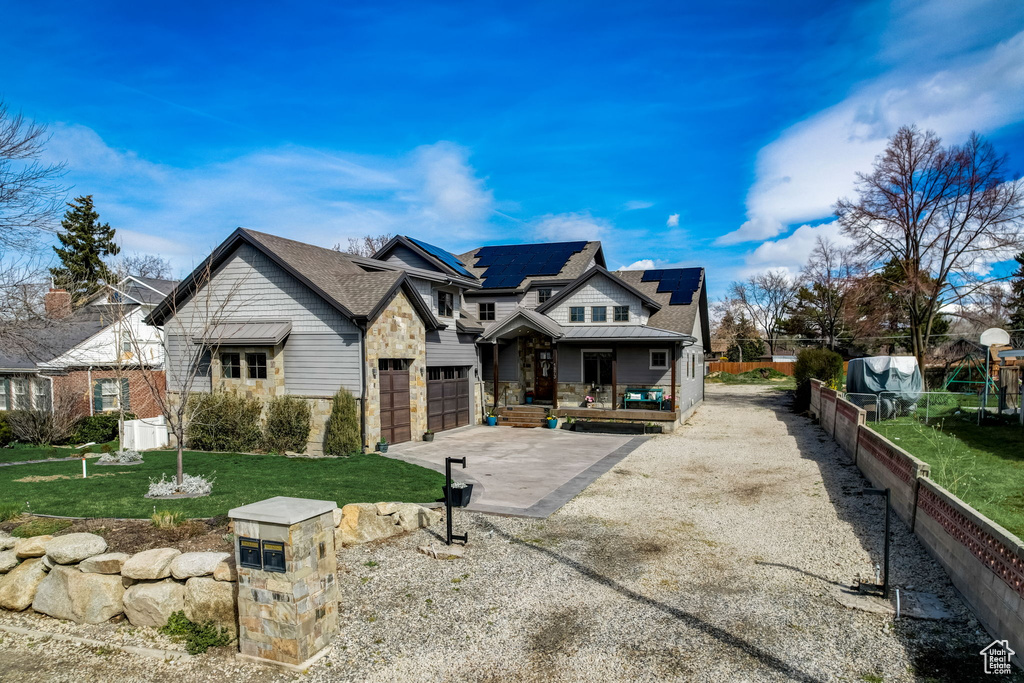 View of front of property featuring a front lawn and a garage