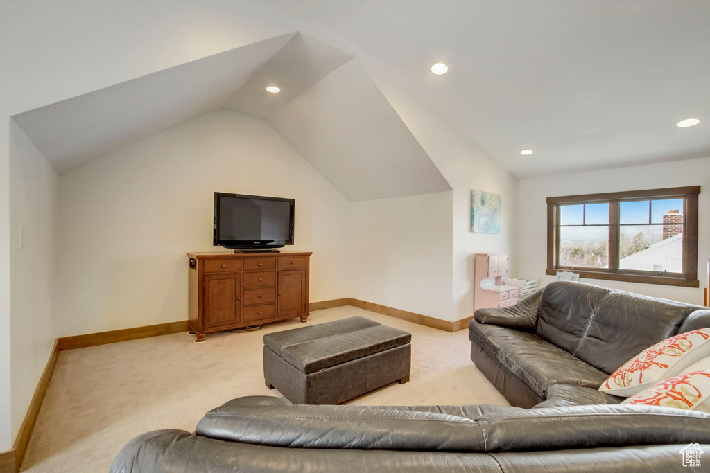 Carpeted living room with vaulted ceiling