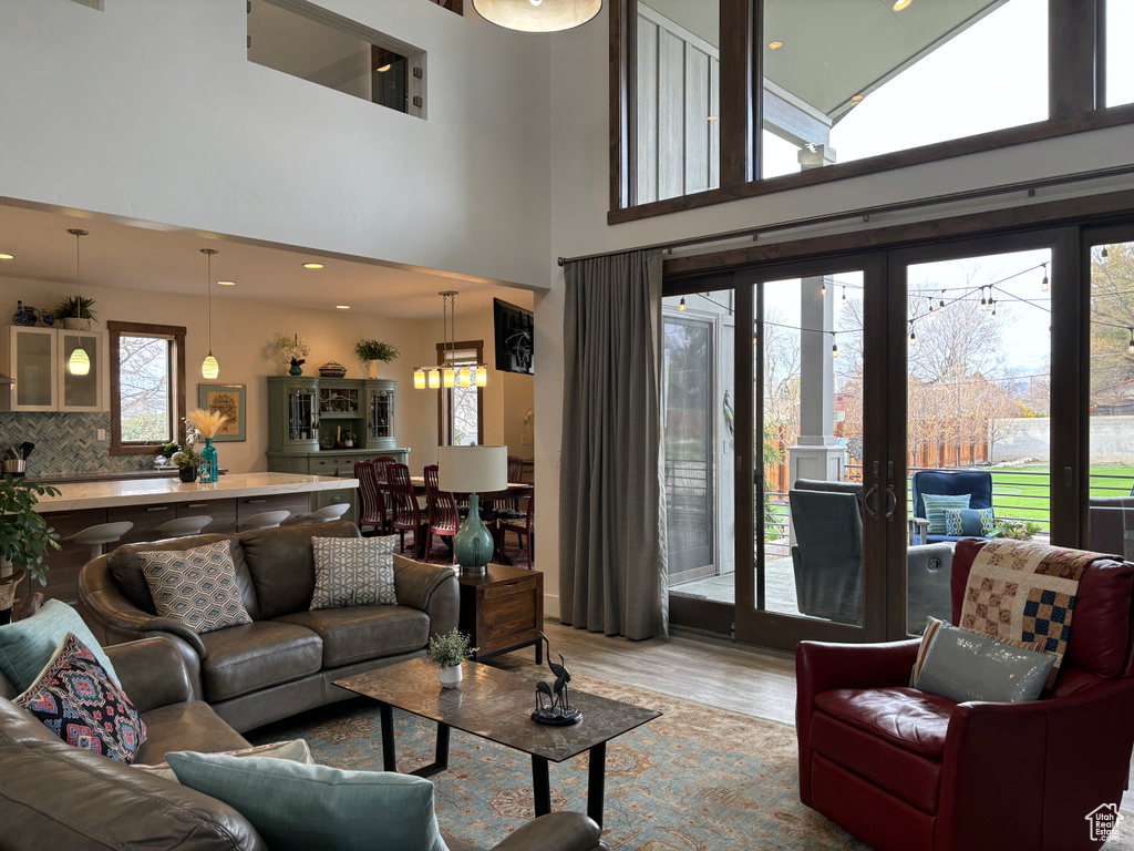 Living room with wood-type flooring and a high ceiling