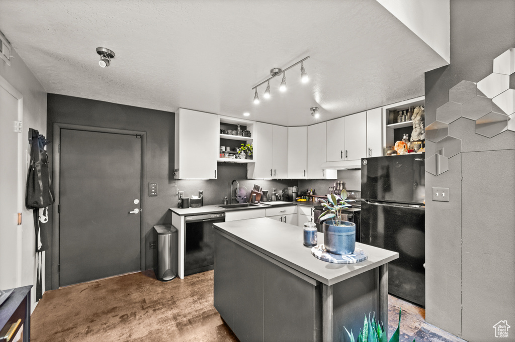 Kitchen with a center island, white cabinetry, black appliances, rail lighting, and sink