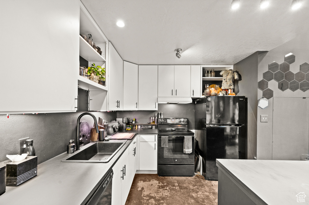 Kitchen featuring white cabinets, sink, and black appliances