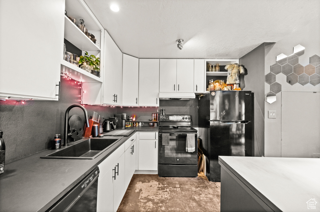 Kitchen featuring black appliances, sink, backsplash, and white cabinetry