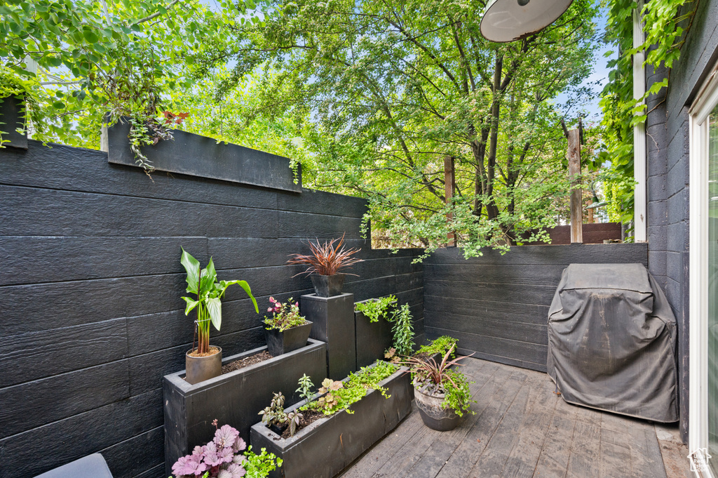 View of terrace with a wooden deck and a grill