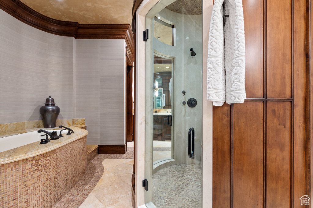 Bathroom featuring tile flooring and a bath to relax in