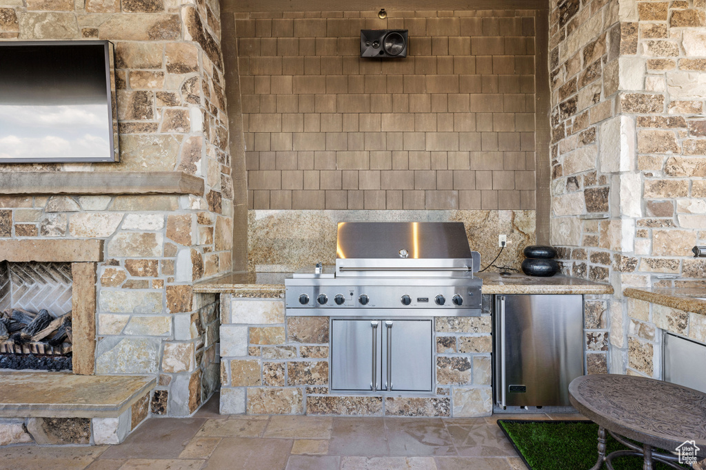 View of patio featuring area for grilling and an outdoor kitchen