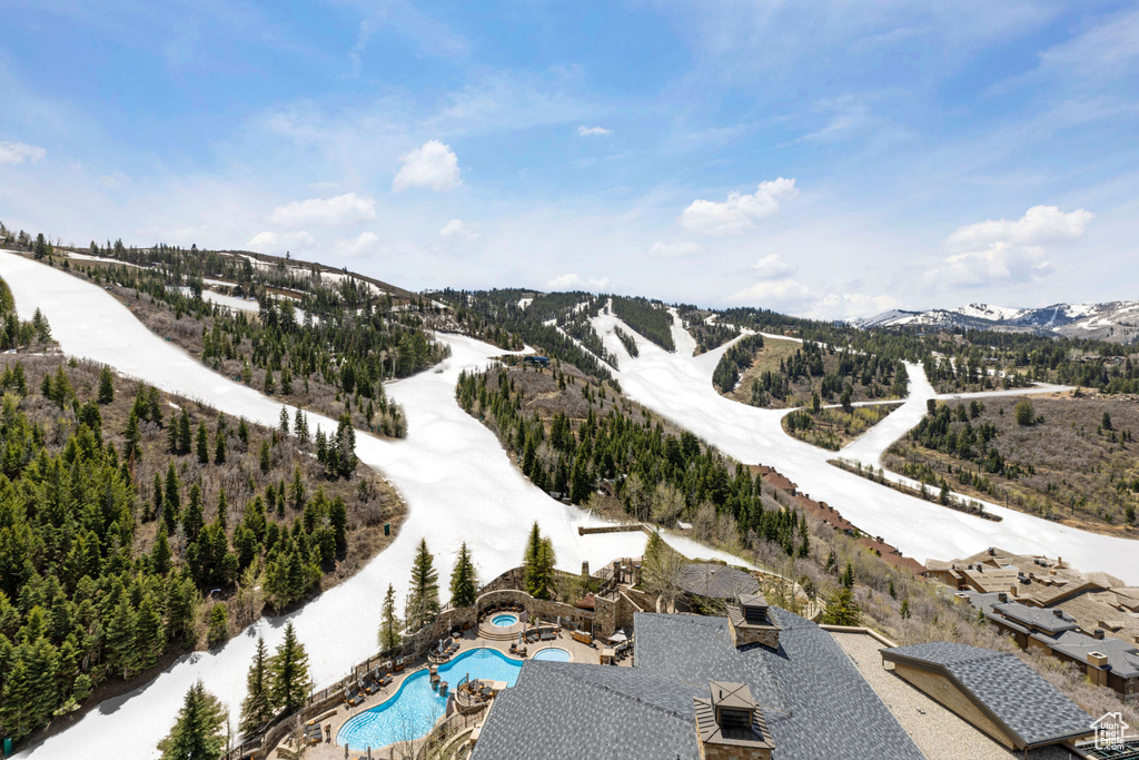 Snowy aerial view featuring a mountain view