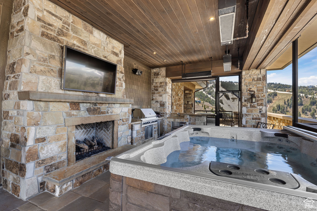 Bathroom featuring tile flooring, a fireplace, and wood ceiling