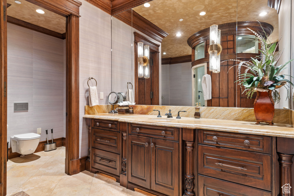 Bathroom featuring tile flooring, ornamental molding, and large vanity