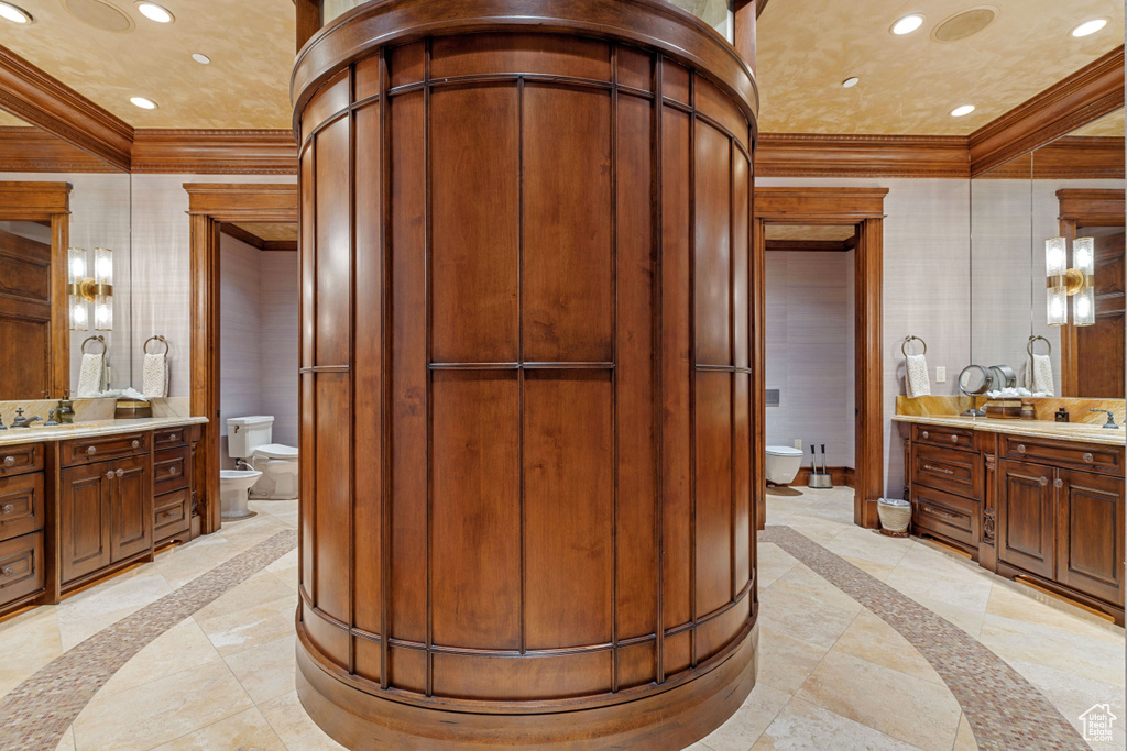 Bathroom featuring a bidet, tile flooring, vanity, and toilet