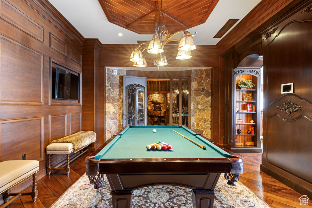 Rec room featuring dark wood-type flooring, built in features, billiards, and wood ceiling