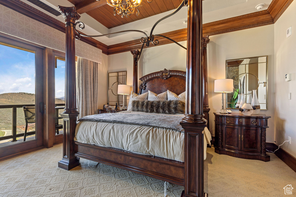 Bedroom with access to exterior, wood ceiling, and multiple windows