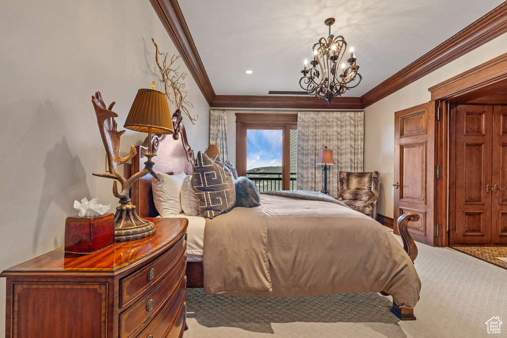 Carpeted bedroom featuring a chandelier and crown molding